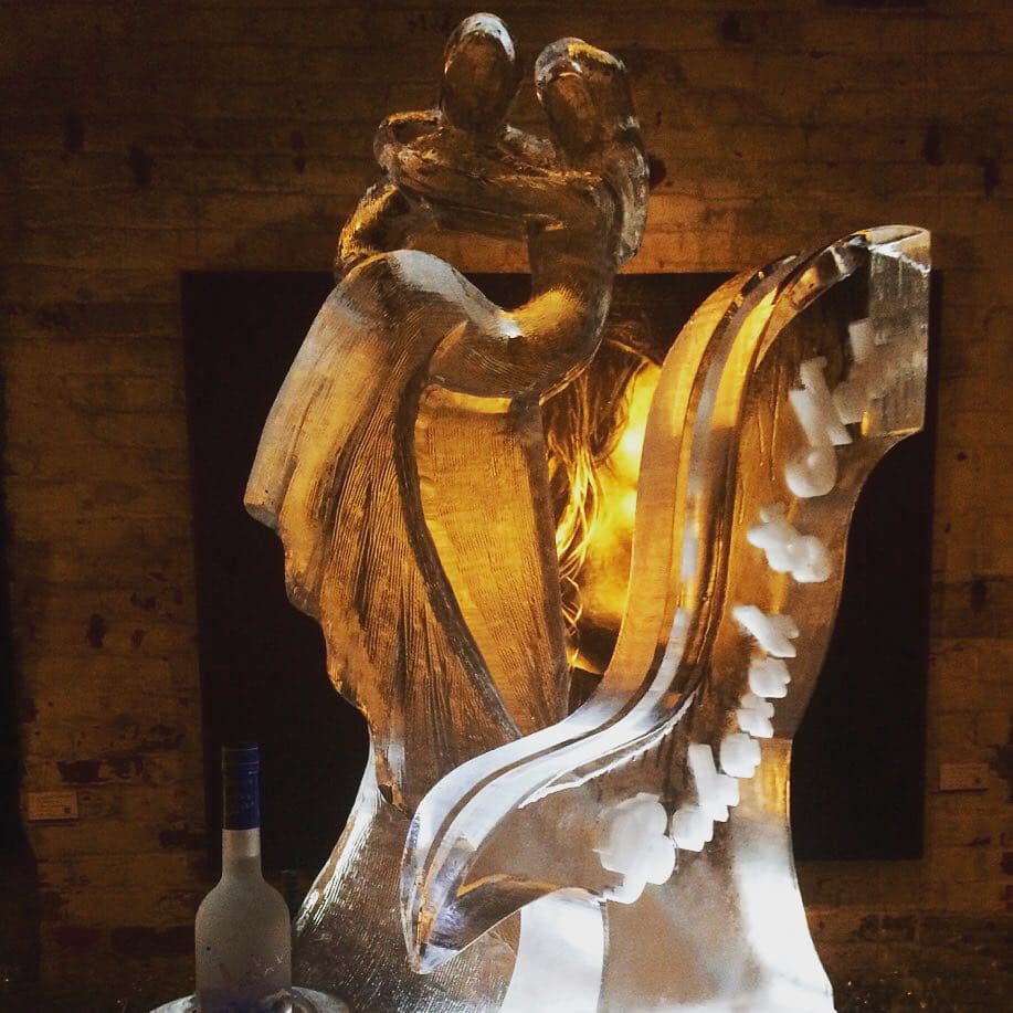 Wedding centerpiece — two figures embracing, warm uplight